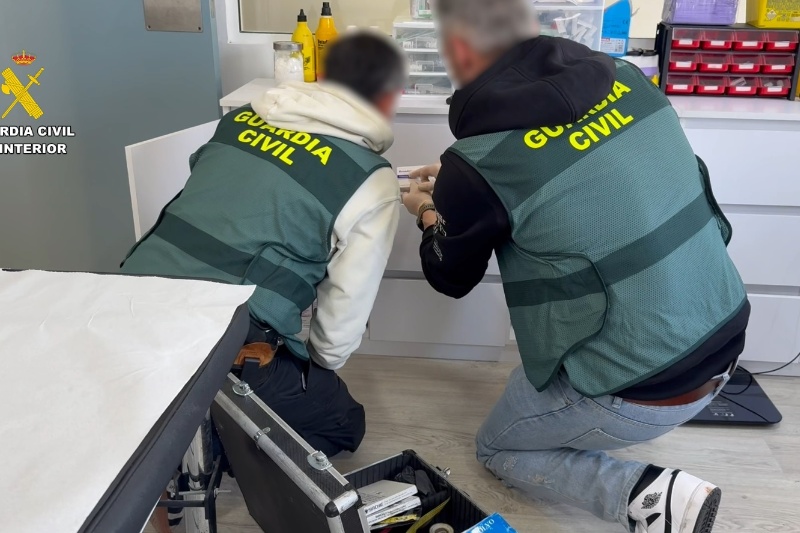 Dos agentes de la guardia civil mirando medicamentos